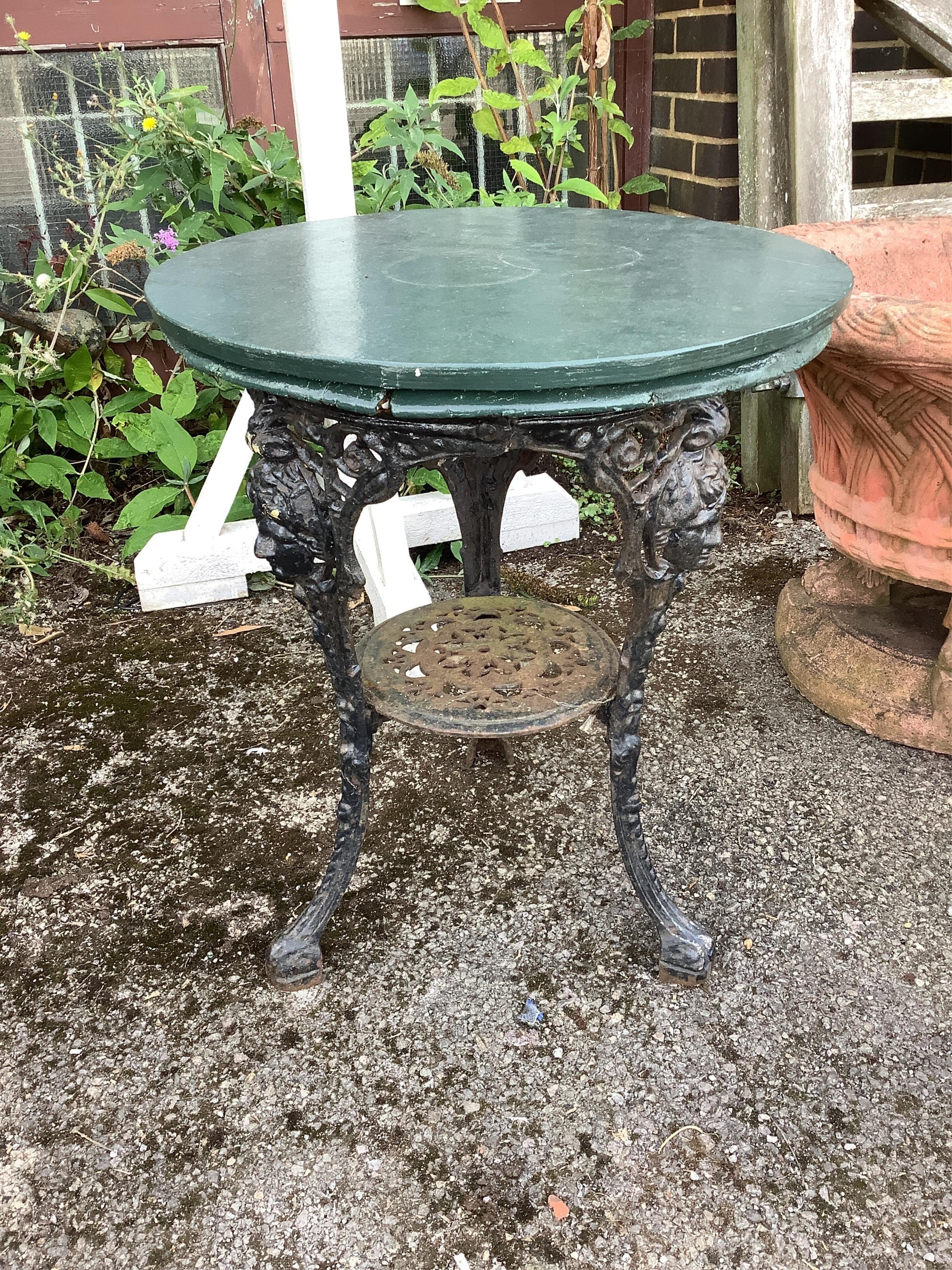 A Victorian circular painted cast iron pub table, with associated top, diameter 62cm, height 71cm. Condition - poor to fair